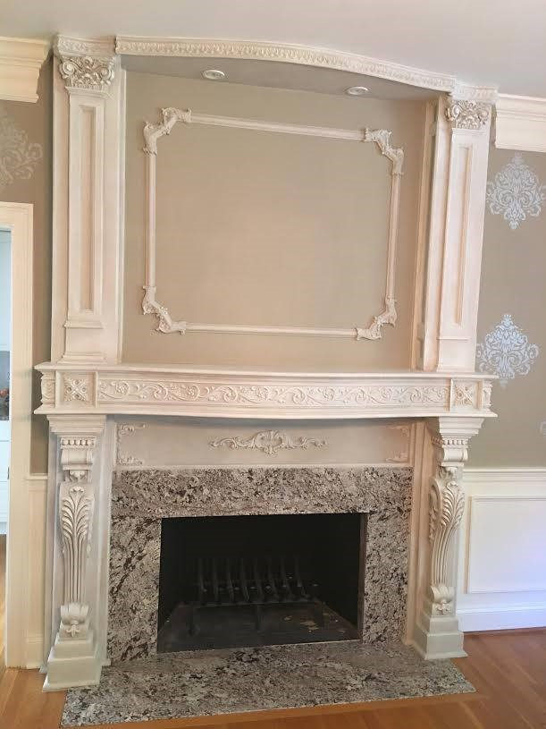 Fireplace surround by Pistritto Marble — carved stone surround with paneled mantel wall