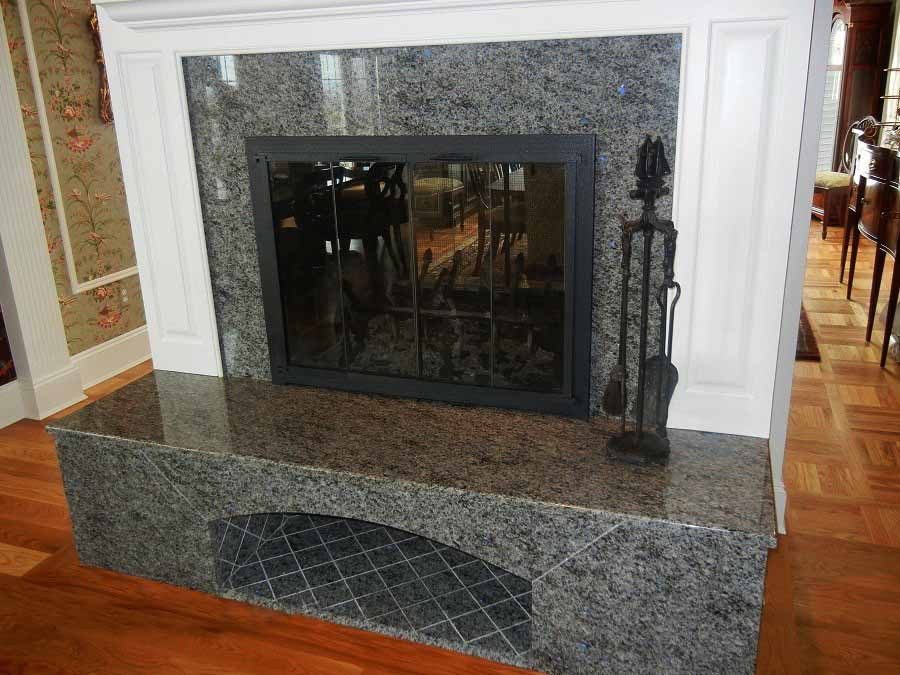Fireplace surround by Pistritto Marble — granite surround with raised hearth