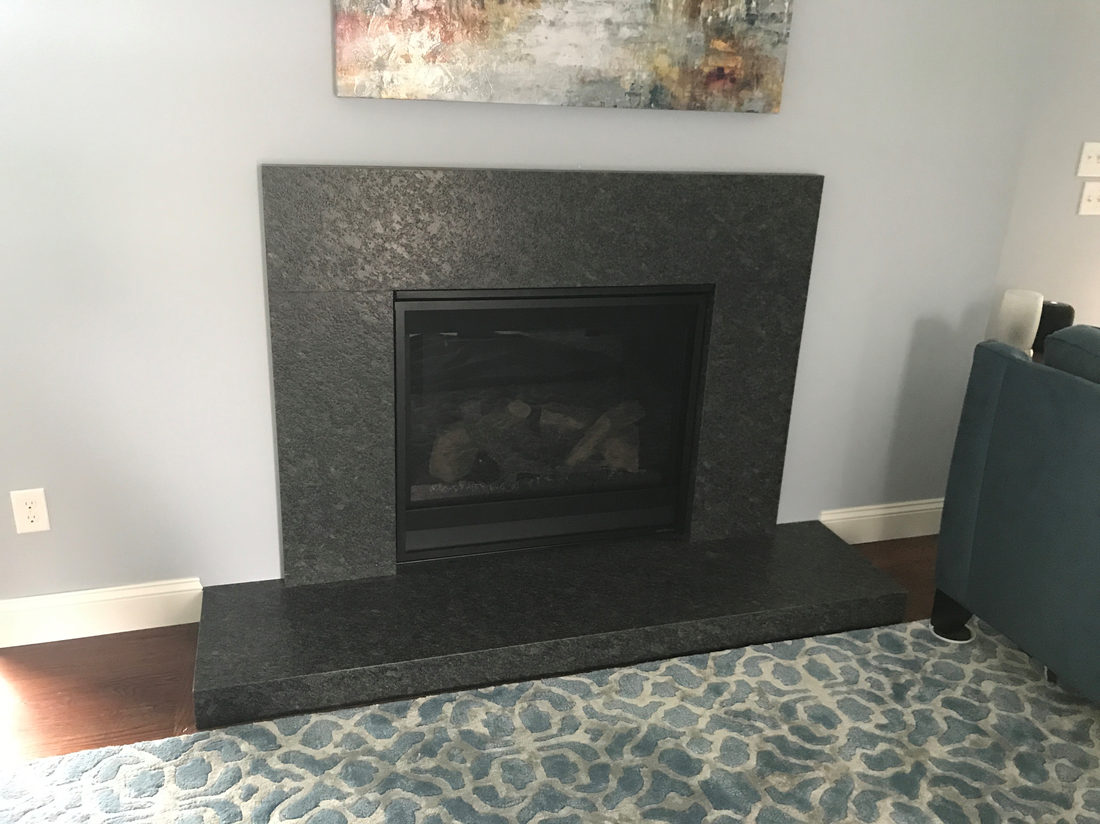 Fireplace surround by Pistritto Marble — gray stone surround with tiled hearth