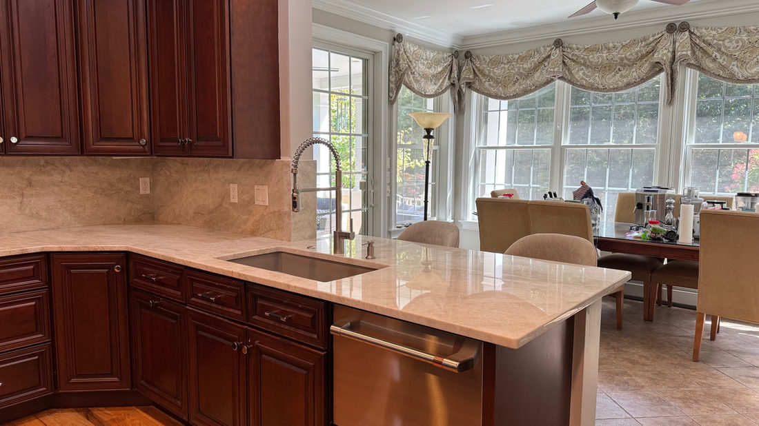 Kitchen countertop project by Pistritto Marble — cherry cabinets with light stone counters