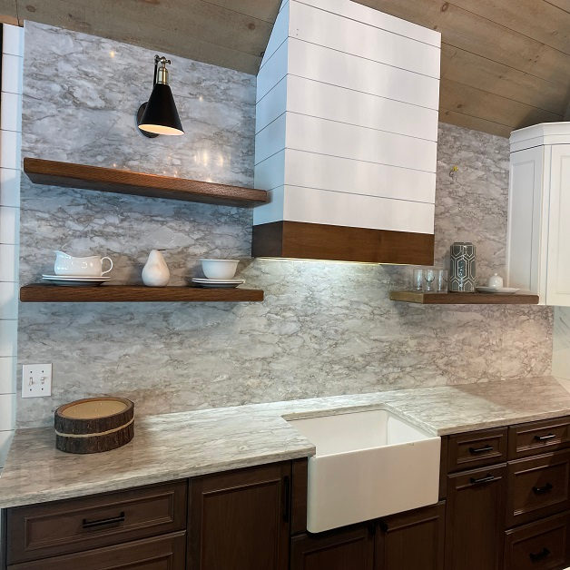 Kitchen countertop project by Pistritto Marble — farmhouse sink with marble backsplash and floating shelves