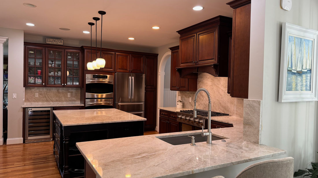 Kitchen countertop project by Pistritto Marble — dark island with veined white top