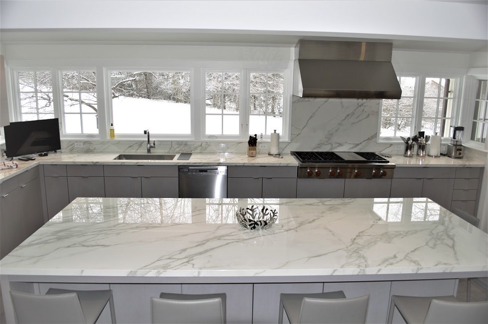 Kitchen countertop project by Pistritto Marble — full kitchen with island and range wall