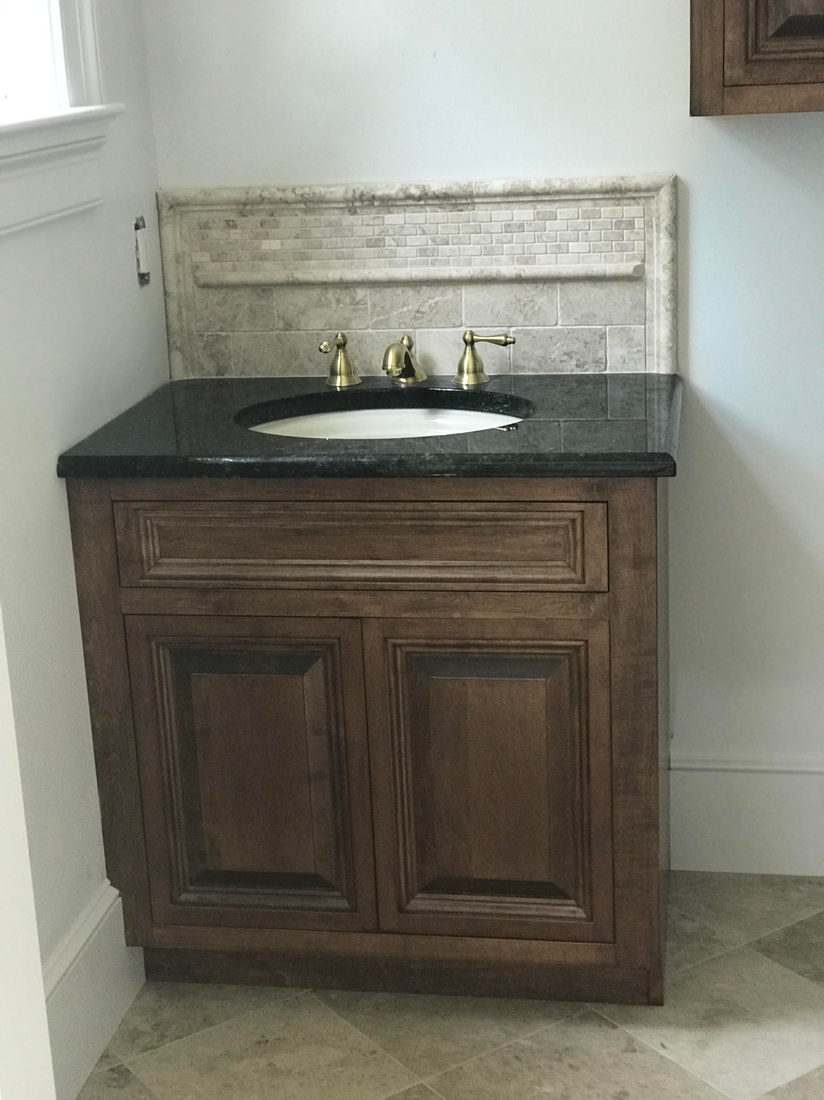 Bath project by Pistritto Marble — wood vanity with dark stone top