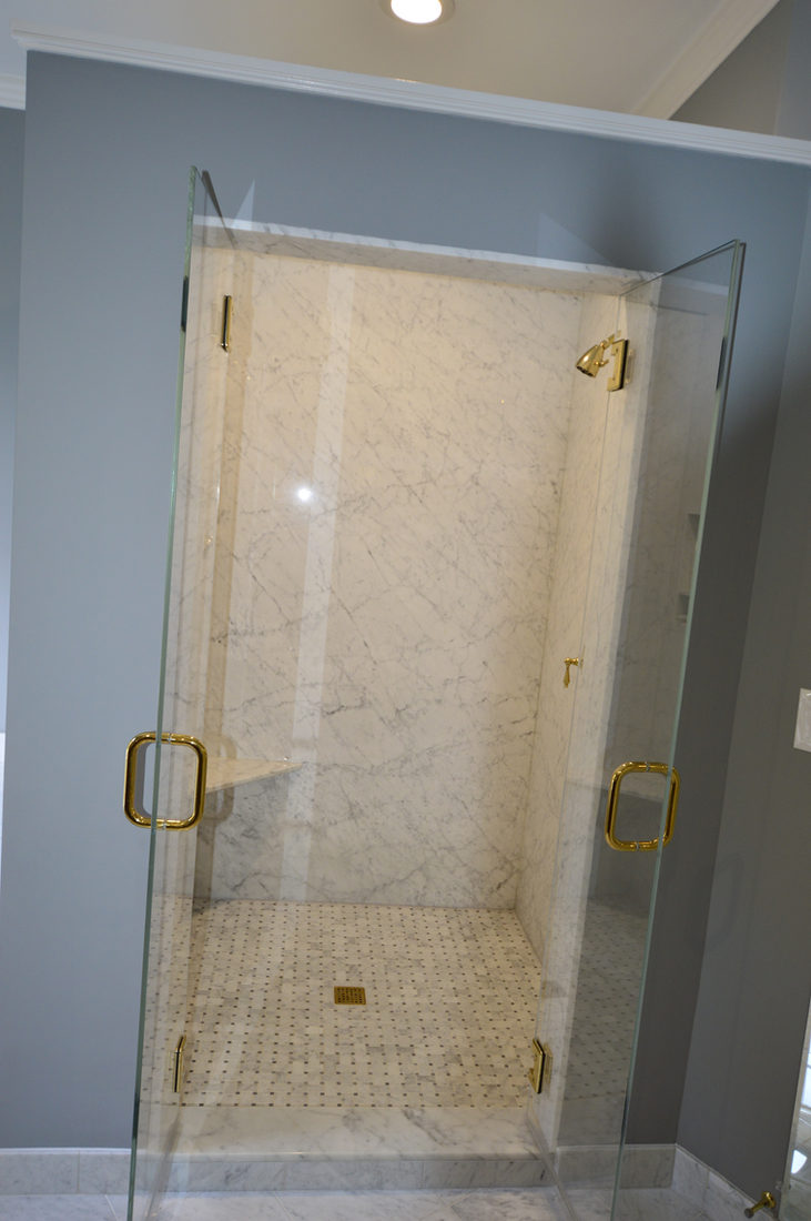 Bath project by Pistritto Marble — glass shower with stone surround