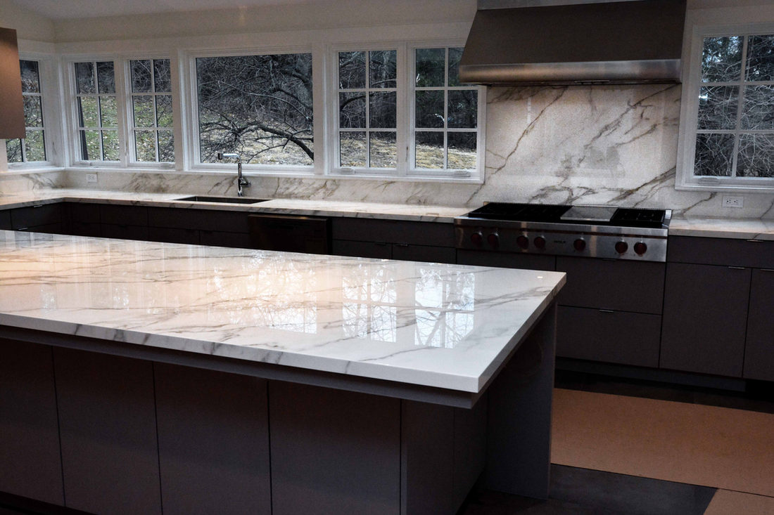 Porcelain surfaces installed in a bright white Connecticut kitchen by Pistritto Marble