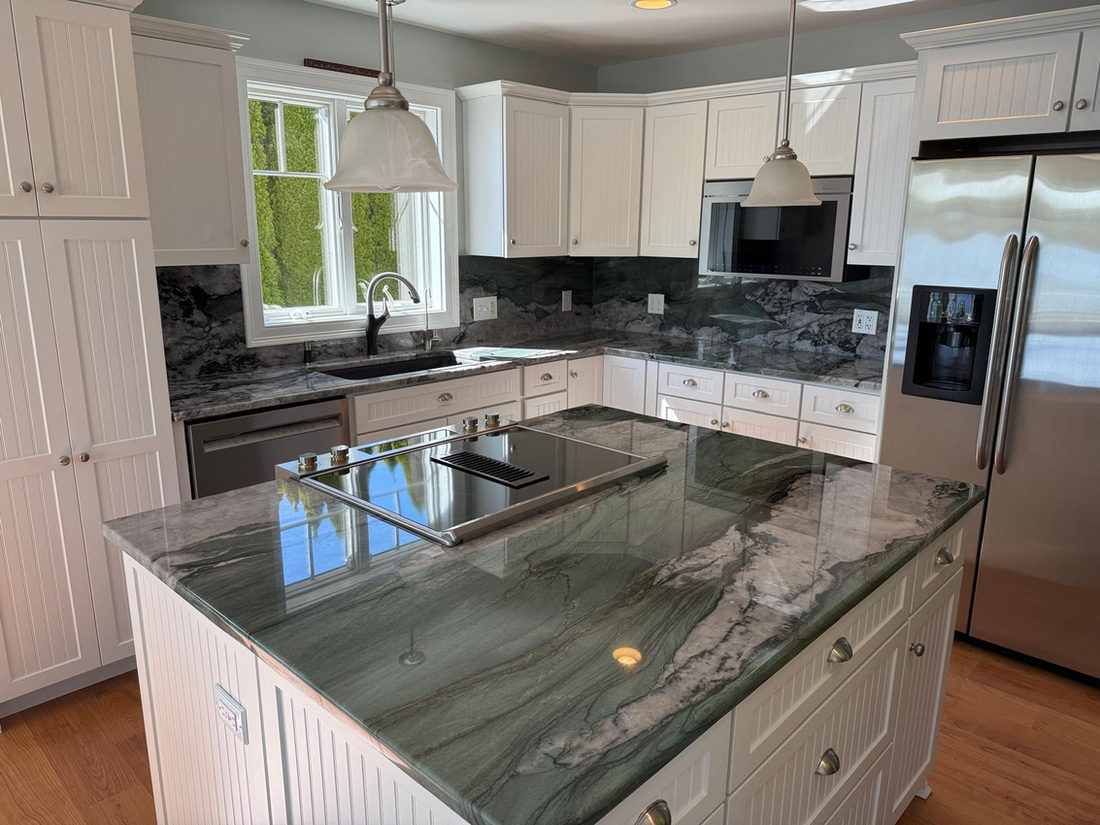 Green quartzite island installed in a white Connecticut kitchen by Pistritto Marble